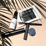 Bodyography Beauty Editor Go-To Collection: From top to bottom - Palm leaves, Mini Ready Set Go Makeup Setting Spray, 10 count Cleansing and Soothing Wipes, Lip Pencil in Pouty, Inner Glow Stick, Fabric Texture Lipstick in Chiffon, Glitter Pigment in Celestial